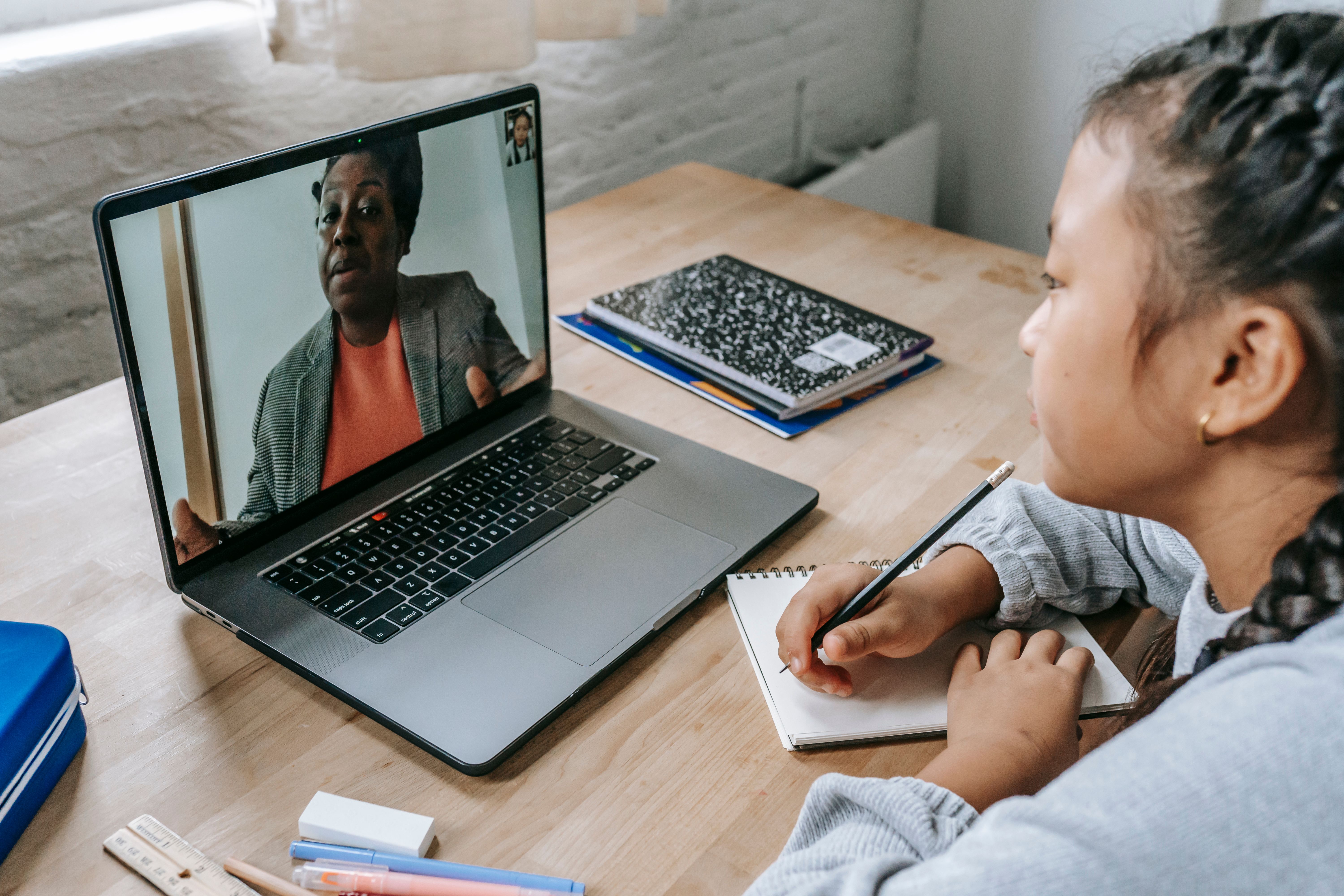 Tutor supporting a K–12 student during an online learning session